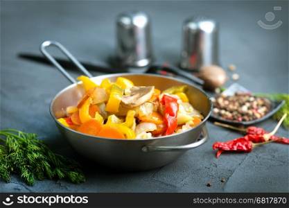baked vegetables in metal bowl and on a table