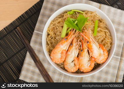 baked vermicelli with shrimp in white cup on wooden background