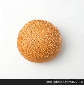 baked whole round bun with sesame seeds made from white wheat flour on a white background, top view