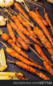 Baked young carrots on the frying pan. Baked carrots