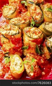 Baked zucchini or eggplant stuffed with cheese. Zucchini rolls with cheese
