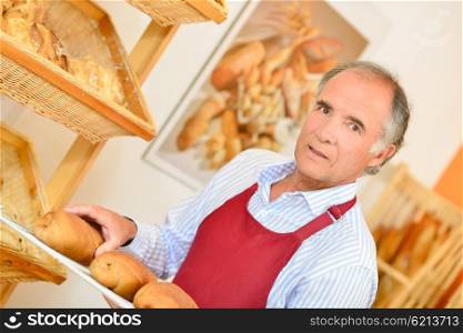 Baker carrying bread on a tray