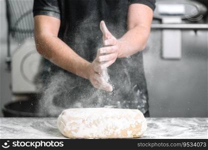 Baker claping hands with flour in restaurant kitchen .. Baker claping hands with flour in restaurant kitchen.