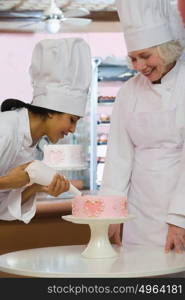 Baker decorating cake