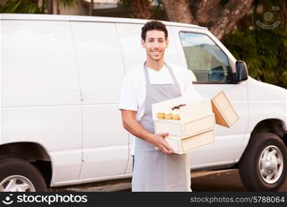 Baker Delivering Cakes Standing In Front Of Van