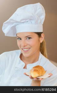 Baker holding a croissant