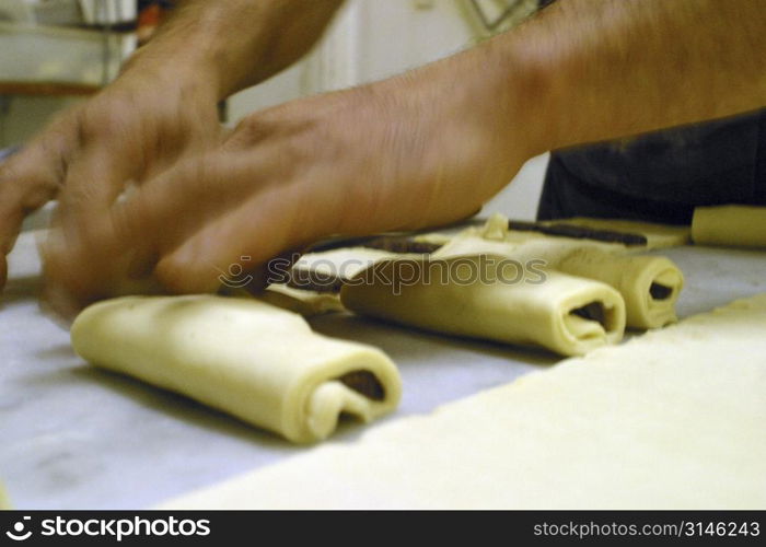 Baker making croissants