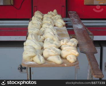 baker manufacturing and baking bread in the street