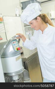 Baker using an industrial bread maker