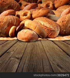 Bakery bread food concept on an old fashioned wood table background with a group of baked goods made from whole wheat and natural grains with international breads as pumpernickel pita focaccia bagel and french baguette.