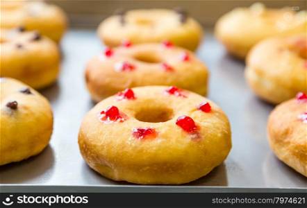 bakery doughnuts with assorted filling on metal tray