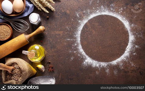 Bakery ingredients for homemade bread baking on table. Flour food round circle for recipe as panoramic top view at stone background texture with copy space, flat lay concept