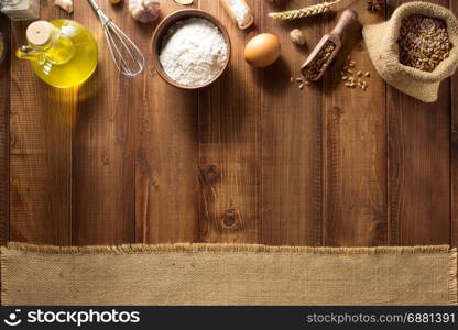 bakery ingredients on wooden plank background