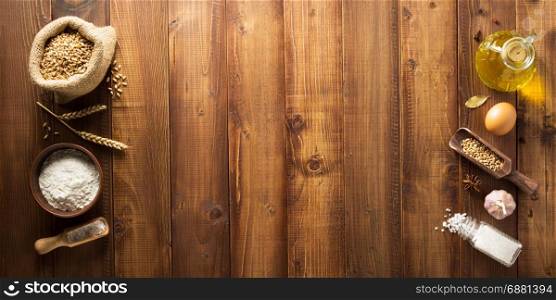 bakery ingredients on wooden plank background