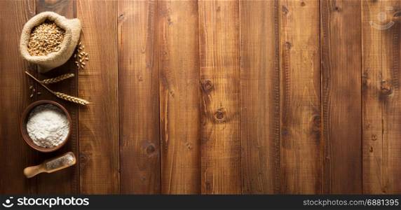 bakery ingredients on wooden plank background
