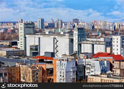Bakery plant in the old district of Podil in Kiev and the roofs of old houses and new buildings in the city on the horizon. Bird?s-eye.. View of the bakery factory in the old district of Podil in Kyiv, surrounded by dense residential buildings.