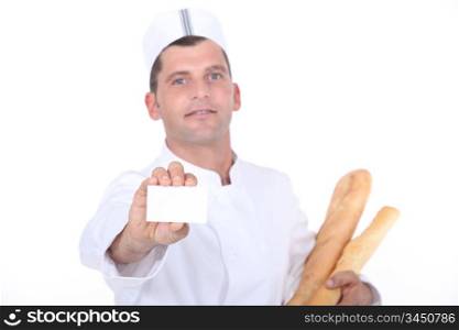 Bakery worker holding out blank business card