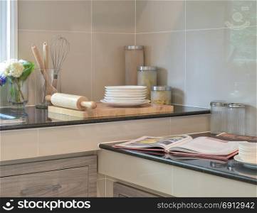 Bakeware set on the black granite top in modern kitchen