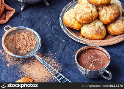 Baking and hot cocoa. Homemade profiteroles dessert and cup hot cocoa