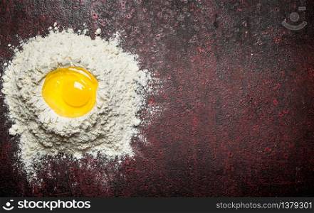 Baking background. Preparation of the dough from flour and fresh eggs. On an old rustic background.. Baking background. Preparation of the dough from flour and fresh eggs.