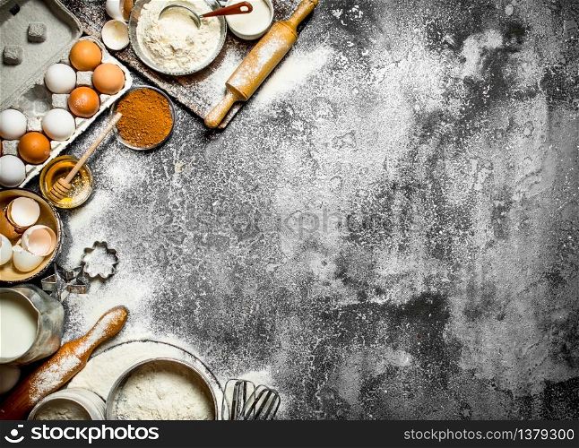 Baking background. Preparation of the dough with the traditional ingredients. On rustic background .. Baking background. Preparation of the dough with the traditional ingredients.