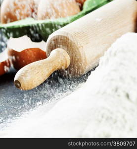 baking background with raw eggs, rolling pin and flour