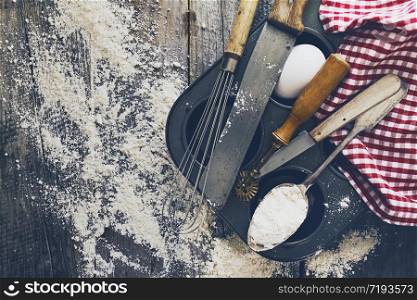 Baking concept kitchen cooking cutlery accessories for baking on wooden background with flour. Top View. Cooking Process. Nobody.