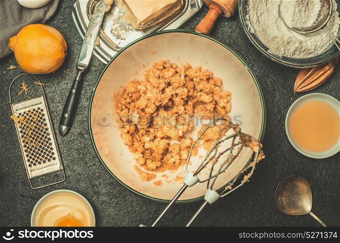 Baking dough cooking preparation with butter and sugar in mixed bowl on kitchen tables with tolls and ingredients, top view