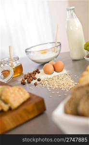 Baking dough ingredients, honey, eggs, flour in kitchen