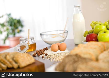 Baking dough ingredients, honey, eggs, flour in kitchen