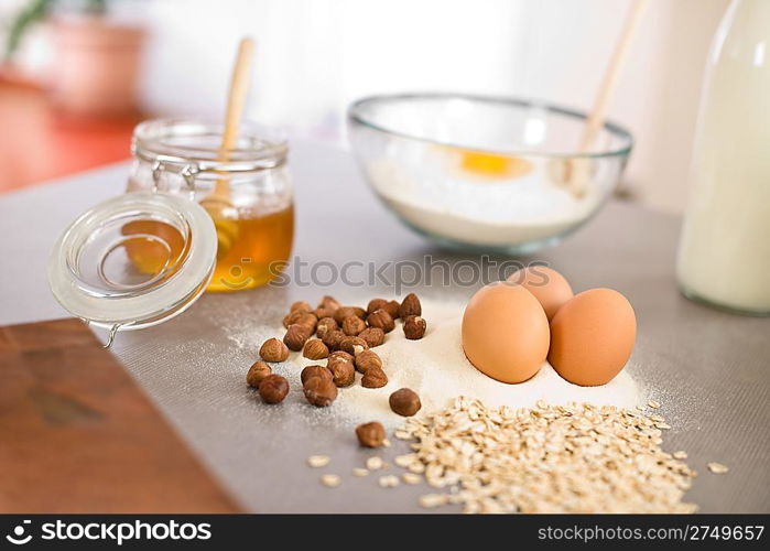 Baking dough ingredients, honey, eggs, flour in kitchen