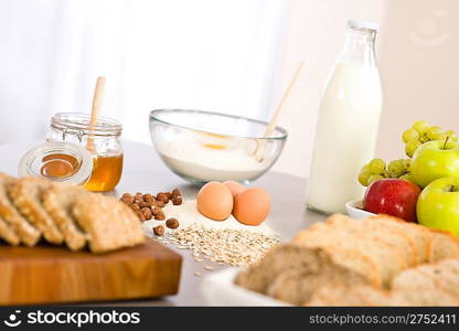 Baking dough ingredients, honey, eggs, flour in kitchen