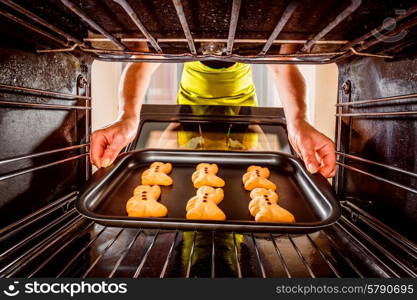 Baking Gingerbread man in the oven, view from the inside of the oven. Cooking in the oven.