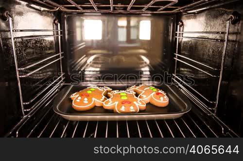 Baking Gingerbread men in the oven. Cooking in the oven.