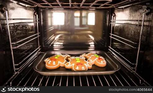Baking Gingerbread men in the oven. Cooking in the oven.