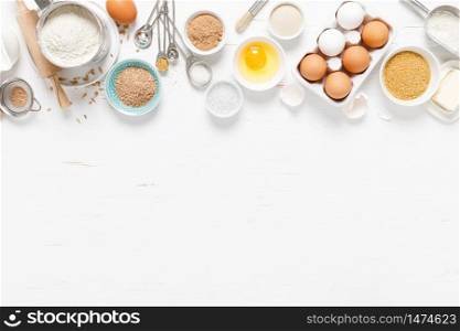 Baking homemade bread on white kitchen worktop with ingredients for cooking, culinary background, copy space, overhead view