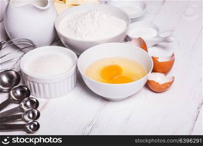 Baking ingredients for pastry on the white table. Baking ingredients on white