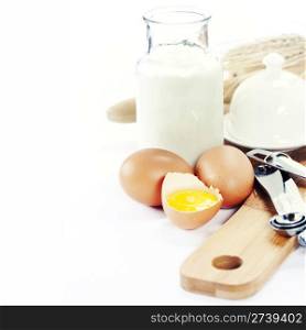 Baking ingredients: milk, eggs and measuring spoons