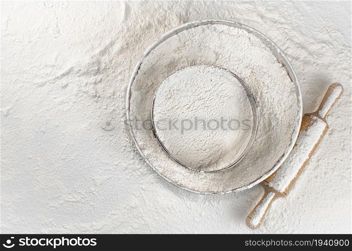 Baking. Sieve in flour. Top view. On a white background. . Baking. Sieve in flour. Top view.