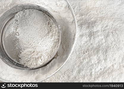 Baking. Sieve in flour. Top view. On a white background. . Baking. Sieve in flour. Top view.