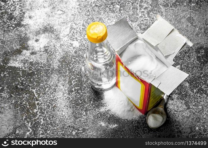 Baking soda with vinegar. On rustic background.. Baking soda with vinegar.