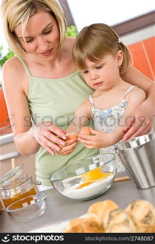 Baking - Woman with child preparing dough with healthy ingredients