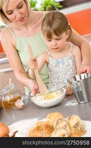 Baking - Woman with child preparing dough with healthy ingredients