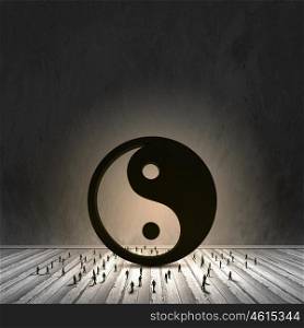 Balance concept. Conceptual image with yin yang sign and silhouettes of businesspeople around