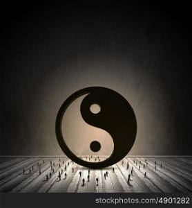 Balance concept. Conceptual image with yin yang sign and silhouettes of businesspeople around