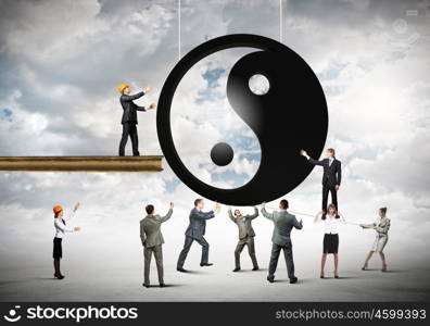 Balance concept. Group of businesspeople and yin yang sign