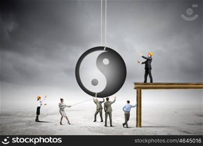 Balance concept. Group of businesspeople and yin yang sign