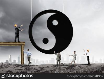 Balance concept. Group of businesspeople and yin yang sign