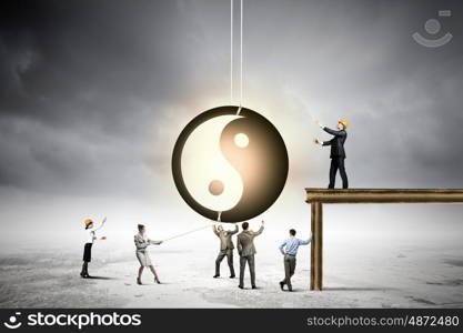 Balance concept. Group of businesspeople and yin yang sign