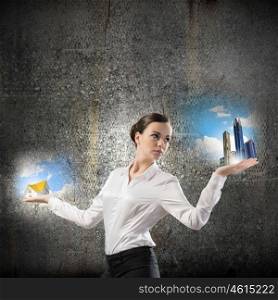 Balance concept. Image of businesswoman holding items on palm. Urban or country
